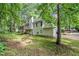 This two-story home features a private backyard, deck, and mature trees bordering the property at 90 Camden Woods Pl, Dallas, GA 30157