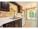 Well-lit kitchen with stainless steel sink, dark wood cabinets, white countertops, and modern appliances at 90 Camden Woods Pl, Dallas, GA 30157