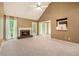 Spacious living room with plush carpeting, a fireplace, vaulted ceiling and lots of natural light from multiple windows at 90 Camden Woods Pl, Dallas, GA 30157
