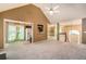 Open-concept living space showcasing a fireplace, plush carpeting and seamless flow into dining and kitchen areas at 90 Camden Woods Pl, Dallas, GA 30157