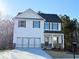 Charming two-story home featuring a welcoming front porch and a spacious two-car garage at 123 Deer Xing, Temple, GA 30179