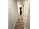 Hallway featuring light gray walls, hard wood floors, and white doors at 123 Deer Xing, Temple, GA 30179