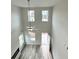 Living room with high ceilings, light wood-look floors, lots of windows, fireplace and a ceiling fan at 123 Deer Xing, Temple, GA 30179