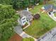 Aerial view of a two-story home with a large front yard, driveway, and surrounding trees at 1482 Pinebark Ct., Grayson, GA 30017