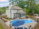 Backyard oasis with a sparkling pool, patio area, and lush greenery at 1482 Pinebark Ct., Grayson, GA 30017