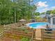 View of backyard pool and raised garden with privacy fence at 1482 Pinebark Ct., Grayson, GA 30017