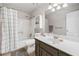 Clean bathroom with vanity, framed mirror, shower over tub with curtain, and vinyl flooring at 1482 Pinebark Ct., Grayson, GA 30017