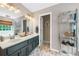 Spacious bathroom featuring double sinks and modern fixtures and open shelving at 1482 Pinebark Ct., Grayson, GA 30017