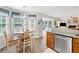 Bright dining area with a chandelier, lots of windows, and wood flooring at 1482 Pinebark Ct., Grayson, GA 30017
