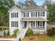 Well-maintained two-story home with a covered front porch and manicured lawn at 1482 Pinebark Ct., Grayson, GA 30017