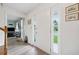 Bright foyer with wood floors, white trim, front door with sidelights, and view into the living room at 1482 Pinebark Ct., Grayson, GA 30017