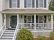 Inviting front porch with chairs and hanging flower baskets at 1482 Pinebark Ct., Grayson, GA 30017