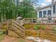 Beautifully landscaped backyard with terraced garden beds and wooden stairs at 1482 Pinebark Ct., Grayson, GA 30017