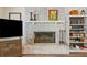 Cozy living room with a brick fireplace, built-in shelving, and a television at 1482 Pinebark Ct., Grayson, GA 30017