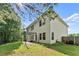 A spacious backyard featuring a lawn, patio with pergola, and white siding of the two-story home at 3235 Avondale Pkwy, Powder Springs, GA 30127