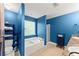 Bright blue bathroom featuring a soaking tub, walk-in shower, and modern fixtures at 3235 Avondale Pkwy, Powder Springs, GA 30127