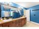 Bathroom showcasing double sinks, wooden cabinets, a large mirror and a walk in shower at 3235 Avondale Pkwy, Powder Springs, GA 30127