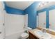 Bright bathroom showcases a single vanity and shower-tub combination with modern fixtures at 3235 Avondale Pkwy, Powder Springs, GA 30127