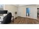 Bedroom with hardwood flooring shows a desk and access to an attached bathroom at 3235 Avondale Pkwy, Powder Springs, GA 30127