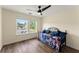 Bedroom with hardwood floors, daybed with decorative pillows, and natural light from two windows at 3235 Avondale Pkwy, Powder Springs, GA 30127