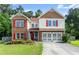 Charming two-story home featuring a brick and siding exterior with a well-maintained lawn and mature trees at 3235 Avondale Pkwy, Powder Springs, GA 30127