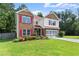 Traditional home with landscaped front yard and two-car garage, offering curb appeal and convenience at 3235 Avondale Pkwy, Powder Springs, GA 30127