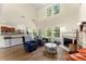 Bright living room with a fireplace, hardwood floors, and large windows, offering a comfortable space at 3235 Avondale Pkwy, Powder Springs, GA 30127