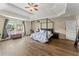 Large main bedroom with a canopy bed and seating area offers comfortable living at 3235 Avondale Pkwy, Powder Springs, GA 30127