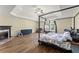 Spacious main bedroom features hardwood floors and a fireplace, with a canopy bed at 3235 Avondale Pkwy, Powder Springs, GA 30127