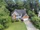 Aerial view of a home nestled among lush green trees in a quiet neighborhood at 5705 Cannonero Dr, Alpharetta, GA 30005