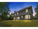 Exterior backyard view of home with large windows, siding, and a spacious lawn at 5705 Cannonero Dr, Alpharetta, GA 30005