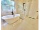 Primary bathroom offers a freestanding soaking tub with a glass-enclosed shower at 5705 Cannonero Dr, Alpharetta, GA 30005