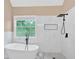 Bright bathroom featuring a soaking tub, walk-in shower with black fixtures, and a large window at 5705 Cannonero Dr, Alpharetta, GA 30005