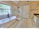 Bright bathroom featuring a soaking tub, walk-in shower with white marble tiling, and sleek fixtures at 5705 Cannonero Dr, Alpharetta, GA 30005