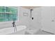 Bathroom featuring walk-in shower, modern tub, and matte black fixtures at 5705 Cannonero Dr, Alpharetta, GA 30005