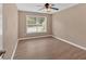 Cozy bedroom featuring a ceiling fan, a window view, and neutral-toned walls at 5705 Cannonero Dr, Alpharetta, GA 30005