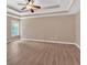 A spacious bedroom enhanced with a tray ceiling, ceiling fan, and large window for natural light at 5705 Cannonero Dr, Alpharetta, GA 30005
