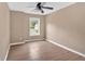 Inviting bedroom with neutral walls, a ceiling fan, and a window for natural light at 5705 Cannonero Dr, Alpharetta, GA 30005
