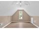 Large bonus room featuring vaulted ceiling, window, wood-look floors, and neutral walls at 5705 Cannonero Dr, Alpharetta, GA 30005