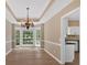 Spacious dining room with beautiful chandelier lighting and natural light from the windows at 5705 Cannonero Dr, Alpharetta, GA 30005