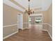Elegant dining room with hardwood floors and a decorative chandelier at 5705 Cannonero Dr, Alpharetta, GA 30005