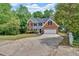 Two-story home with brick and siding exterior, attached garage, and a well-maintained lawn at 5705 Cannonero Dr, Alpharetta, GA 30005
