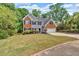 Charming home with brick and siding exterior, attached two-car garage, and a lush green lawn at 5705 Cannonero Dr, Alpharetta, GA 30005