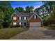 Charming two-story home with brick and siding, black shutters, and a well-manicured lawn at 5705 Cannonero Dr, Alpharetta, GA 30005