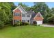 Charming two-story home with brick and siding, black shutters, and a well-manicured lawn at 5705 Cannonero Dr, Alpharetta, GA 30005