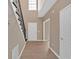 Bright foyer featuring hardwood floors, staircase with black metal railing, and white doors at 5705 Cannonero Dr, Alpharetta, GA 30005