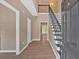 Bright foyer with high ceilings, wood floors, staircase, and open view to the home's interior at 5705 Cannonero Dr, Alpharetta, GA 30005