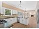 Modern kitchen featuring white cabinets, stainless steel appliances and a view into the living room at 5705 Cannonero Dr, Alpharetta, GA 30005