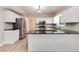 Well-lit kitchen featuring stainless steel appliances, granite countertops and white cabinets at 5705 Cannonero Dr, Alpharetta, GA 30005