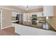 Bright kitchen featuring stainless steel appliances, dark countertops, and a stylish backsplash at 5705 Cannonero Dr, Alpharetta, GA 30005